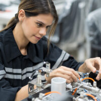 Female engineer training AI robot training kit and mechatronics engineering in the manufacturing automation and robotics academy room